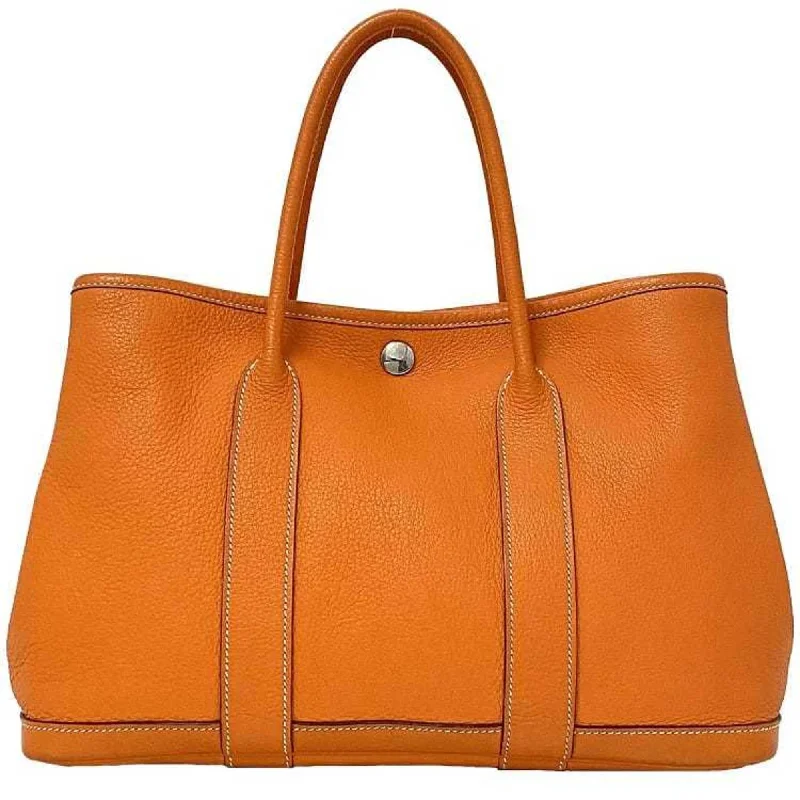 Handle bags with playful pom-poms for charm -Hermes Garden  Leather Handbag Tote Bag (Pre-Owned)