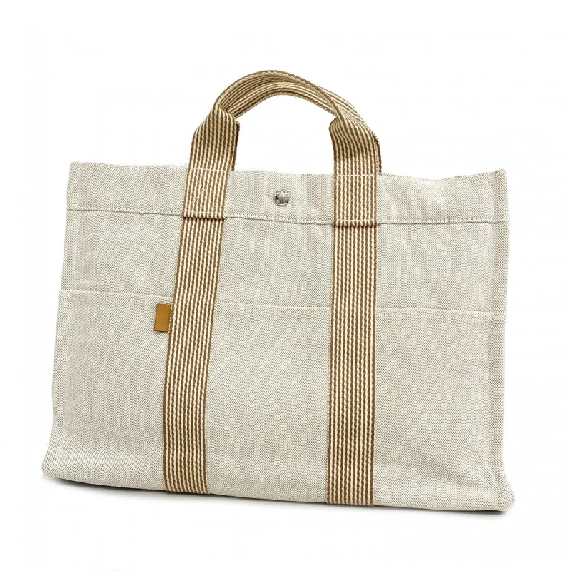 Handle bags with colorful handles for flair -Hermes  ivory Canvas Tote Bag (Pre-Owned)