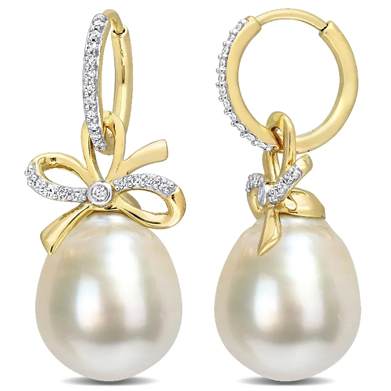 Best hoop earrings with marbled designs for a trendy and artistic effect-Miadora 12-12.5mm Oval Golden South Sea Cultured Pearl & 1/4 CT TW Diamond Bow Huggie Earrings in 14k Yellow Gold